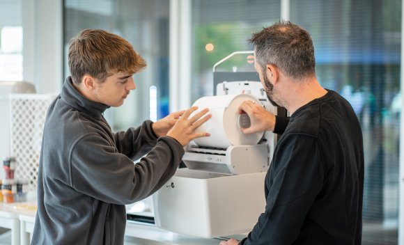 Mitarbeiter von Ulticom arbeiten an einem Papierspender