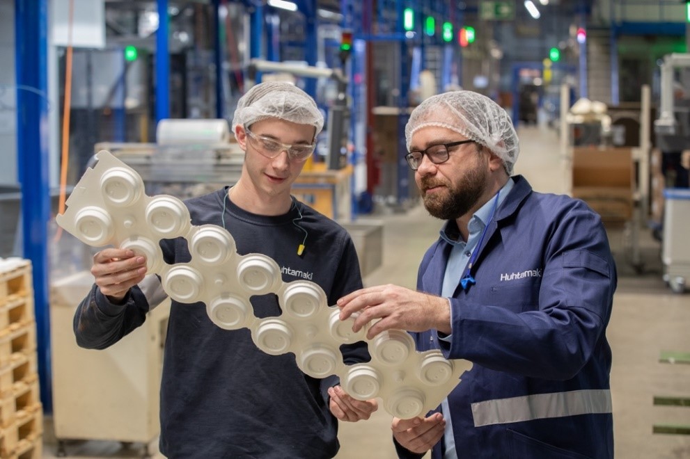 Huhtamaki Geschäftsführer mit Mitarbeiter in der Produktion