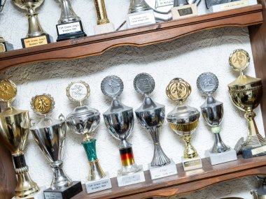Pokale der Pressta-Mitarbeiter in einem Schrank