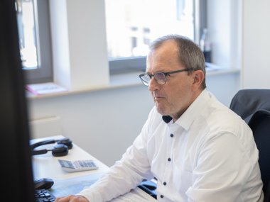 Mitarbeiter der Sparkasse Mittelmosel Ein Mitarbeiter der Sparkasse Mittelmosel am Schreibtisch